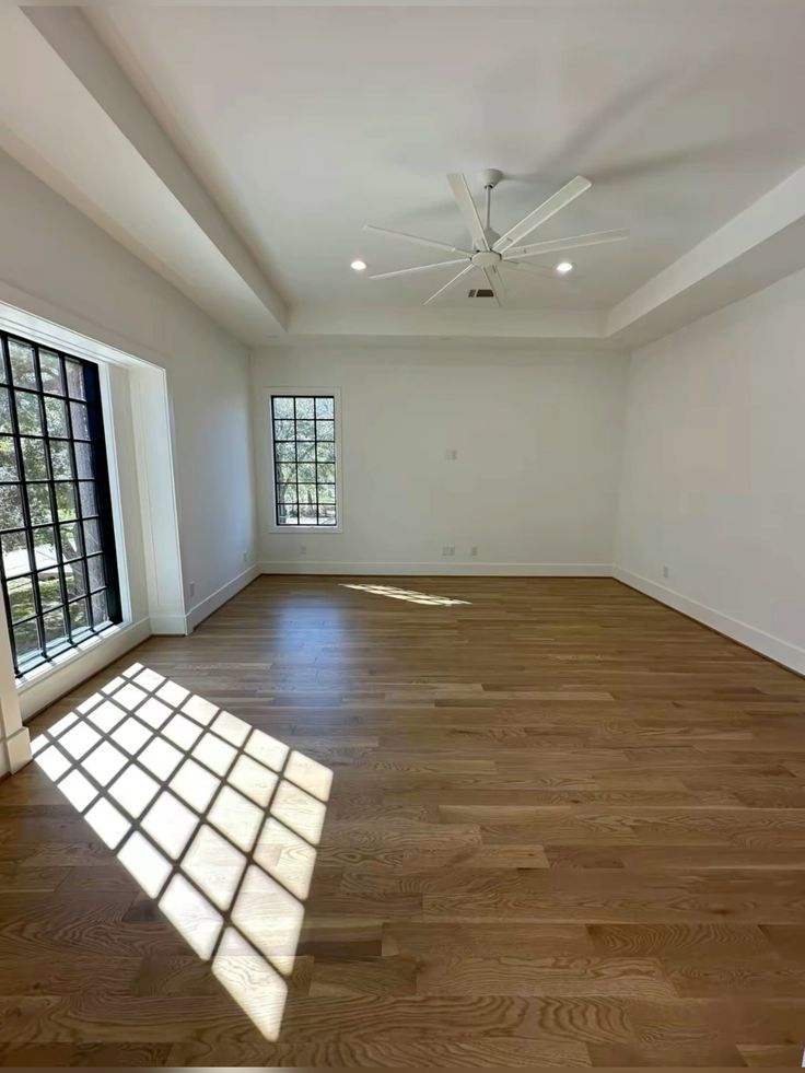 Primary suite addition at Elmwood, with wide-plank oak floors and a coffered ceiling